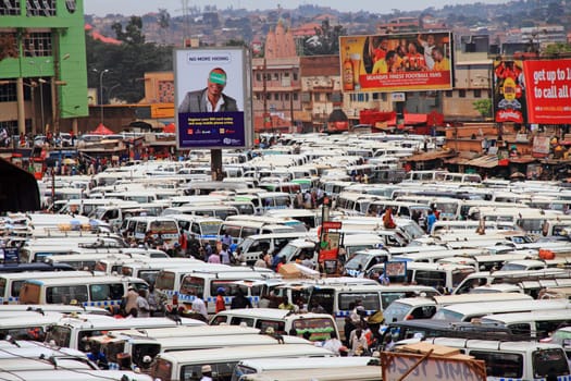 KAMPALA, UGANDA - SEPTEMBER 28, 2012. The public transportation hub in downtown Kampala, Uganda. Taxis (buses) wait for passengers in the large and crowded taxi park in Kampala, Uganda, on September 28, 2012.