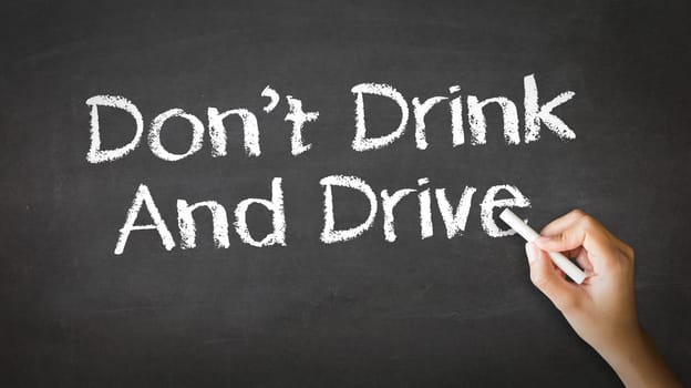 A person drawing and pointing at a Don't Drink And Drive Chalk Illustration