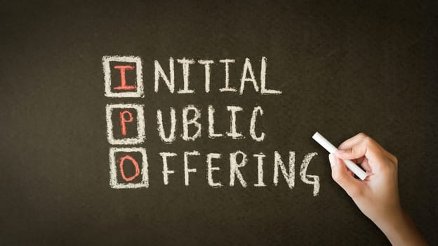 A person drawing and pointing at a Initial Public Offering Chalk Drawing