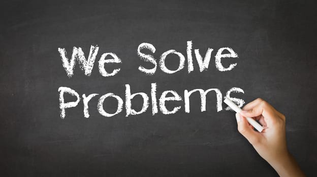 A person drawing and pointing at a We Solve Problems Chalk Illustration