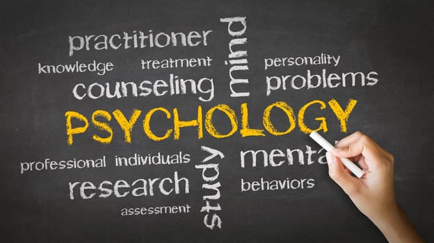 A person drawing and pointing at a Psychology Chalk Drawing.