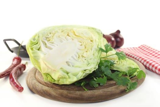 a sliced pointed cabbage on a wooden board