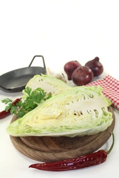 a sliced pointed cabbage on a wooden board