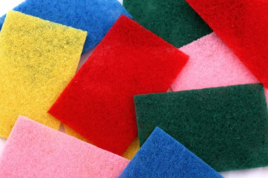 A lot of sponges in different colors background.