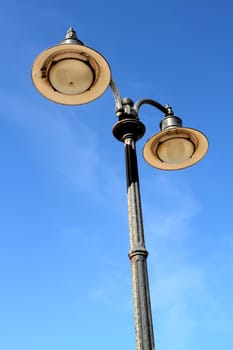 An aged and oxidise lamp post .