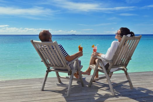 happy young couple relax and take fresh drink at summer vacation