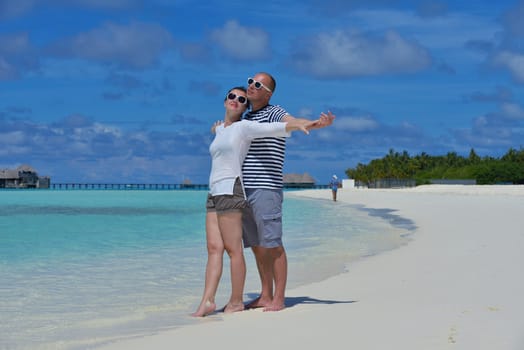 happy young  couple at summer vacation have fun and relax at beautiful sunny  day on beach