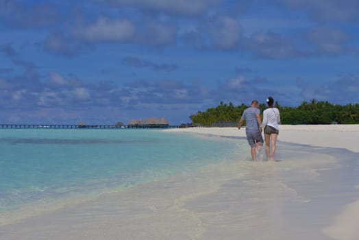 happy young  couple at summer vacation have fun and relax at beautiful sunny  day on beach