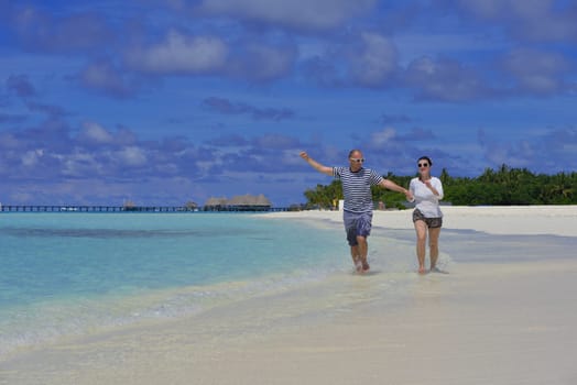 happy young  couple at summer vacation have fun and relax at beautiful sunny  day on beach