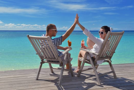 happy young couple relax and take fresh drink at summer vacation