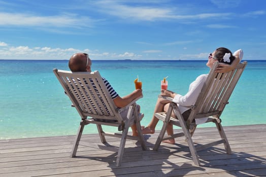 happy young couple relax and take fresh drink at summer vacation