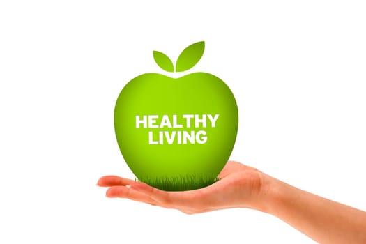 Hand holding a green healthy living apple.