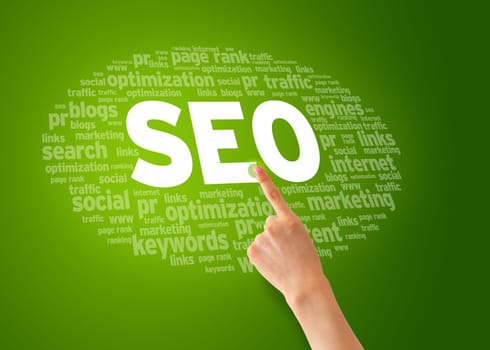 Hand pointing at a Search Engine Optimization Word Cloud.