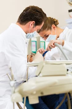 Patient at dentist - treatment with drilling