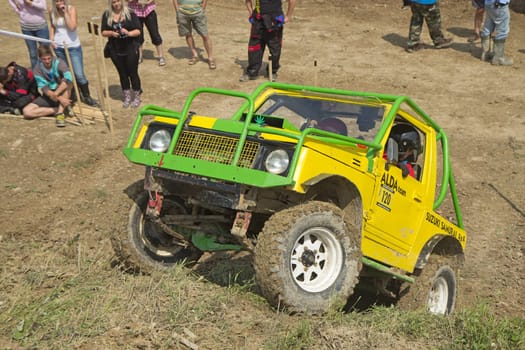 ZAMBERK, CZECH REPUBLIC - JULY 06. Yellow off-road car on a steep slope in the "BIG SHOCK CUP Trial 2013"" on July 06, 2013  in the town of Zamberk, Czech Republic."