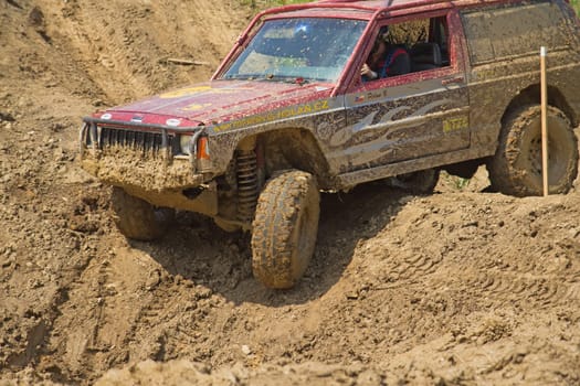 MOHELNICE, CZECH REPUBLIC - JUNE 09. Red off-road car on a steep slope in the "BIG SHOCK CUP Trial 2013"" on June 09, 2013  in the town of Mohelnice, Czech Republic."
