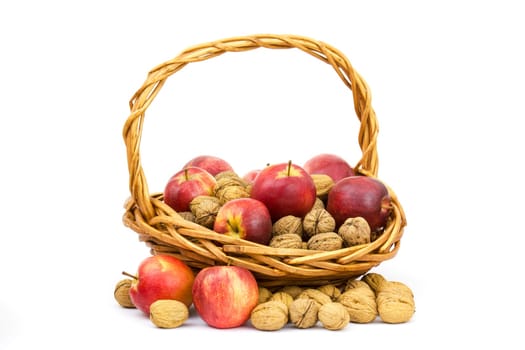 basket full of whole walnuts and apples