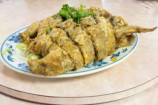 Glutinous Rice Deep Fried Stuffed Whole Chicken Chinese Dish Garnished with Cilantro