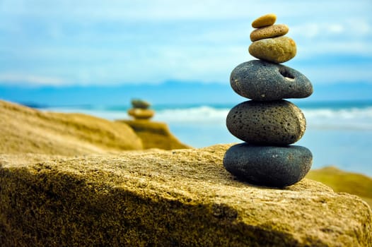 Zen Stone stacked together on blue coud background.