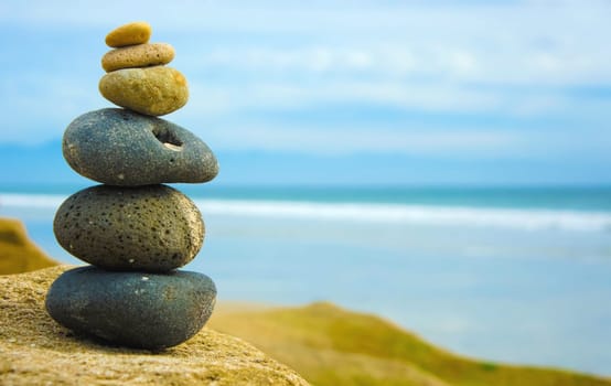 Zen Stone stacked together on blue blurred background