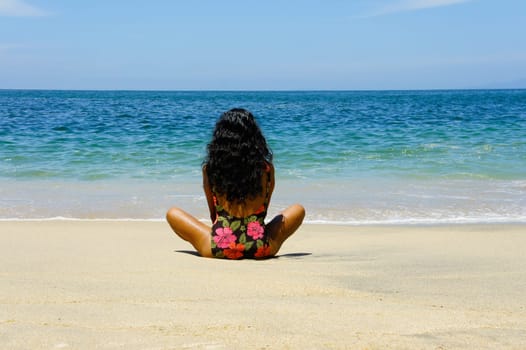 Latin Woman relaxing at a tropical beach