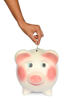 Piggy bank and hand with coin isolated on white backgroung