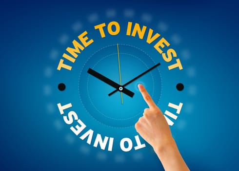 Hand pointing at a Time to invest clock on blue background.