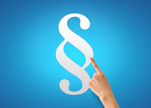 Hand pointing at a paragraph sign on blue background.