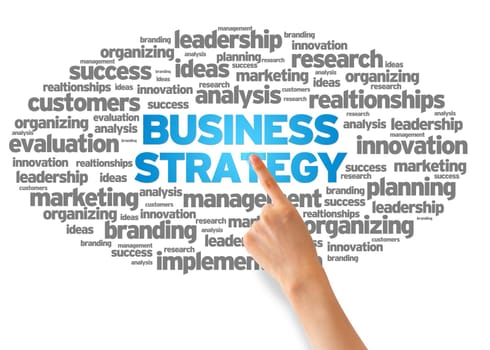 Hand pointing at a Business Strategy Word Cloud on white background.