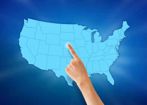 Hand pointing at a United States map on blue background.