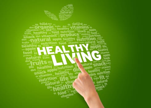 Finger pointing at an Healthy Living Apple on green background.