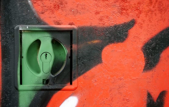 A lock of an electrical distribution box painted with paint.