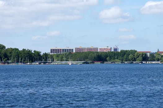 The photograph of a harbour and skyscrapers on Lake Mueritz.