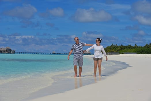 happy young  couple at summer vacation have fun and relax at beautiful sunny  day on beach