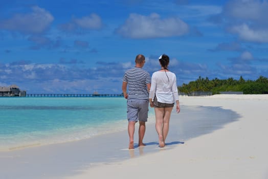 happy young  couple at summer vacation have fun and relax at beautiful sunny  day on beach