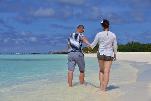 happy young  couple at summer vacation have fun and relax at beautiful sunny  day on beach