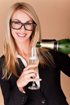 A businesswomen woman holding a glass of champagne at a party.