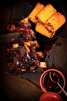 Beef ribs cooked on the BBQ and served with sweetcorn and a red wine souse.