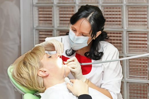 Female patient in chair at dentist office