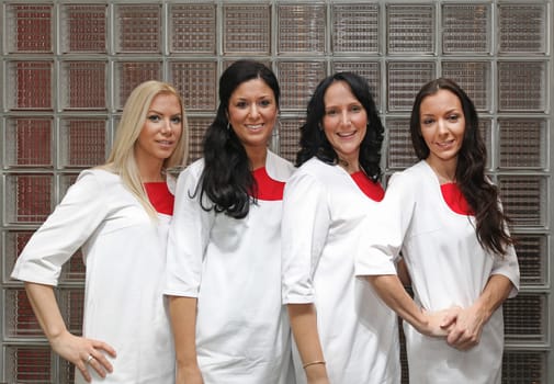 Four female doctors in wearing white uniforms
