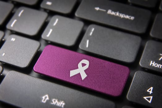 Health key with Cancer ribbon icon on laptop keyboard. Included clipping path, so you can easily edit it.