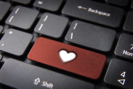 Online Love concept key with heart icon on laptop keyboard. Included clipping path, so you can easily edit it.