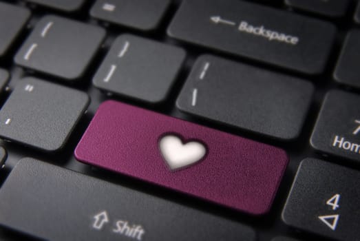 Online Love concept key with heart icon on laptop keyboard. Included clipping path, so you can easily edit it.