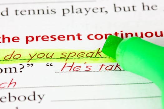 Learning language - English.  Green marker on the exercise book.