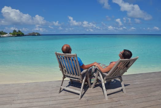 happy young couple have fun and relax at summer vacation on background maldives travel location and beautiful white sand beach