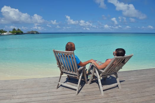 happy young couple have fun and relax at summer vacation on background maldives travel location and beautiful white sand beach