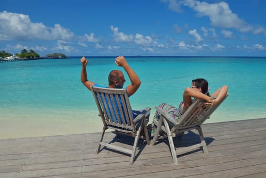 happy young couple have fun and relax at summer vacation on background maldives travel location and beautiful white sand beach