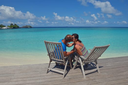 happy young couple have fun and relax at summer vacation on background maldives travel location and beautiful white sand beach