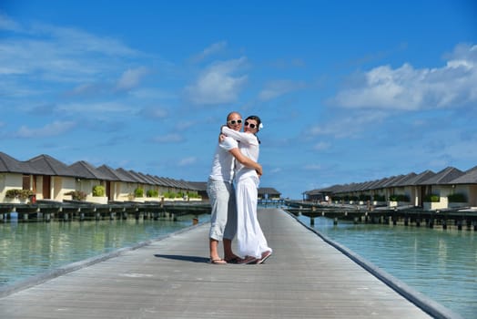 happy young couple have fun and relax at summer vacation on background maldives travel location and beautiful white sand beach