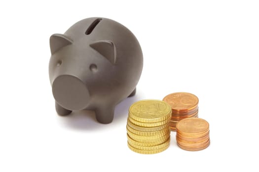 Black piggy bank and coins on white